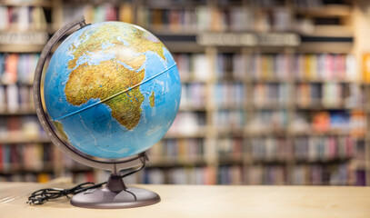 A globe as school equipment placed on a shelf in the school library.