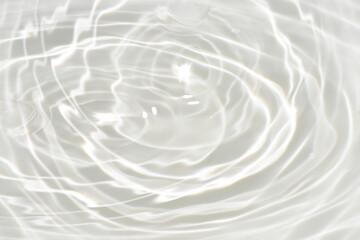Fototapeta na wymiar Defocus blurred transparent white colored clear calm water surface texture with splashes reflection. Trendy abstract nature background. Water waves in sunlight with copy space. Blue watercolor shine.