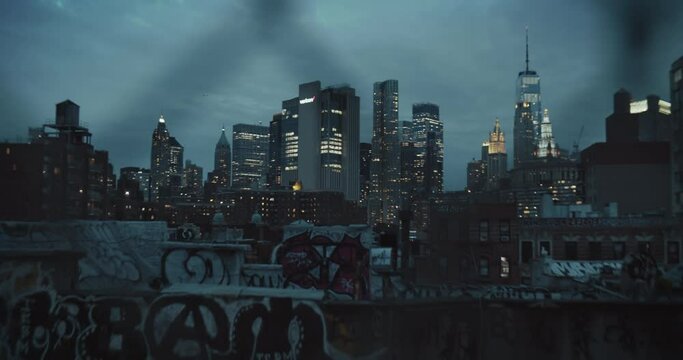 EDITORIAL: NEW YORK CITY, THE UNITED STATES OF AMERICA - 2023: Lower Manhattan Architecture at Night. Panorama with Business District with Skyscrapers and Residential Rooftops with Graffiti Art