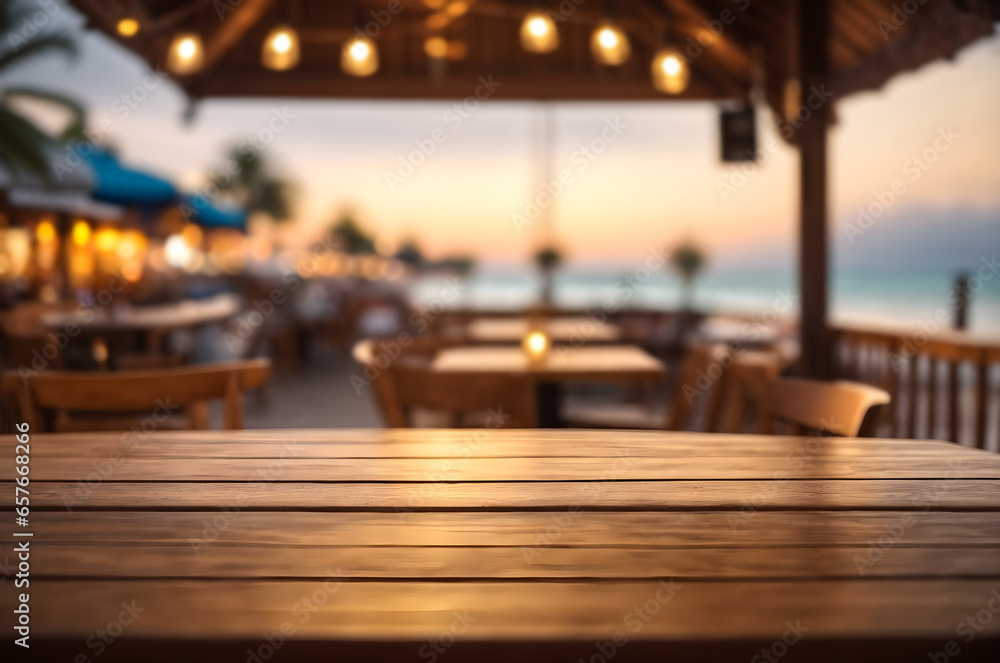 Poster empty wooden table with blur beach cafes background and bokeh lights