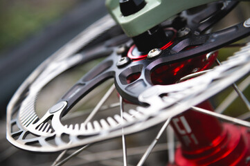 Fototapeta premium Close-up of a mountain bike element. Shallow depth of field frame detail and brake disc of mountain bike hydraulic brakes