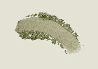 Cosmetic loose powder swatch . Eye shadow khaki green smudge brush stroke isolated on beige