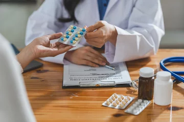 Tuinposter doctor or pharmacist advises patients about pills. The doctor prescribes medication sitting at a table in the clinic office. to find the best course of treatment. follow-up treatment © crizzystudio