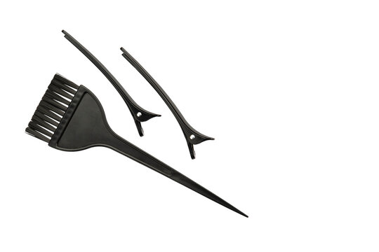 Hair dye brush, black hair clips. Isolated background.