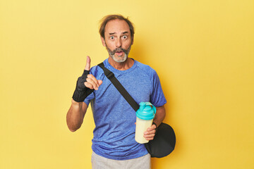 Gym-goer with protein shake in studio having an idea, inspiration concept.