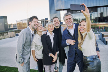 group of business people taking a selfie all together celebrating their start up small business...