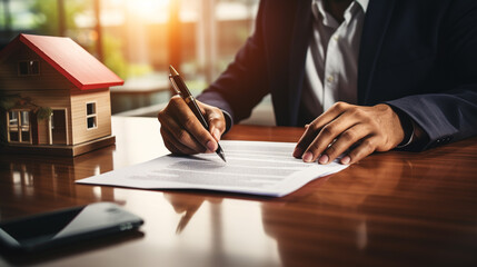 real estate agent is signing a contract to sell a house