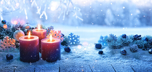 Christmas Decorations With Candles On A Snowy Background. Winter Forest Landscape