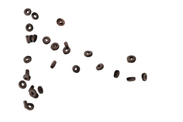 Chocolate rings cereal spill out into a bowl. Breakfast.