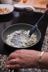 Closeup of fresh onion on a pan. Cooking healthy food.