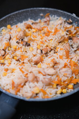 Closeup of delicious rice with vegetables on a pan. Cooking healthy food.