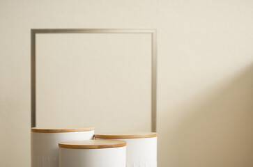 Minimal wood white podium with blurred golden frame on gold beige background.Beauty cosmetic new...