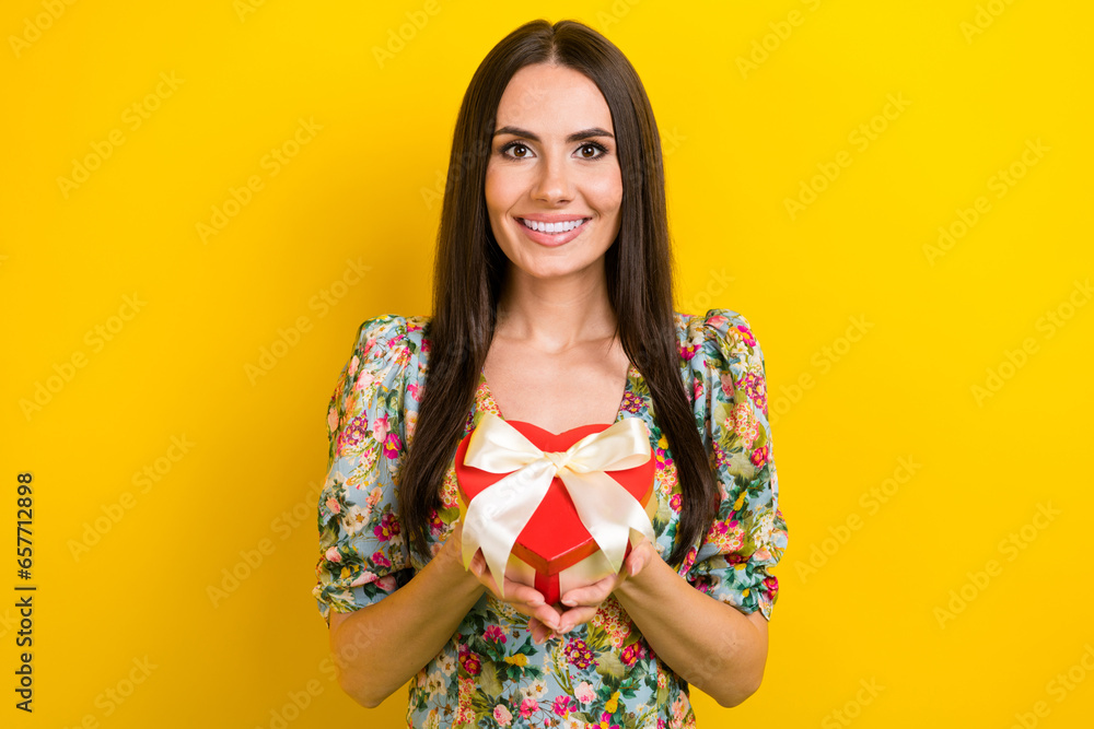 Poster Portrait of candid sincere woman with long hairstyle wear stylish clothes hold heart shape box isolated on yellow color background