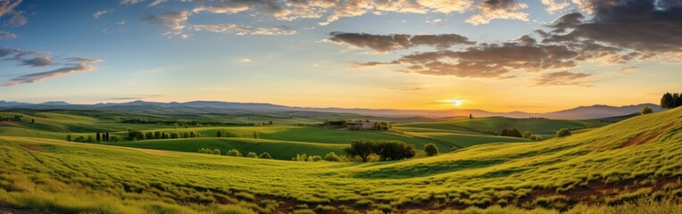 Obraz premium Panoramic view captures the breathtaking landscape of rolling hills bathed in the warm glow of a setting sun. The image evokes a sense of peace, beauty, and the grandeur of nature.