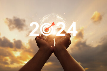 Man hands open palm up with 2024 and goal icon at sunset. business goals trends 2024. planning new...