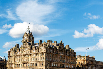 Fototapeta na wymiar Histroical building with clock tower and Scottish flag on top, Edinburgh, Scotland, United Kingdom, Europe