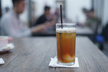 Lychee tea or lychee tea. Iced Tea or Fresh Drink in a glass with a cafe background