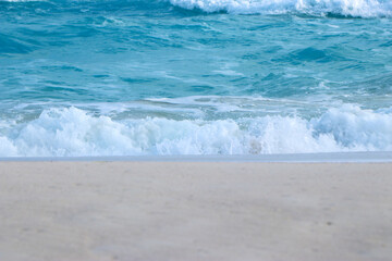 Blue and aquamarine color sea waves and yellow sand with white foam. Marine beach background. Banner format.Tropical Beach Beautiful sea summer spring sand beach blue ocean 
