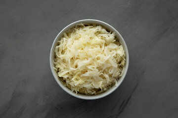 Homemade German Sauerkraut in a Bowl on a gray background, top view.