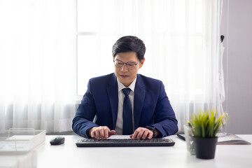 Businessman making video call conference. Asian business male wearing glasses looking at camera and talking online conference