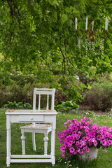 vintage table and chair, chandelier hanging on the tree - wedding decor 