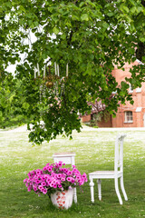 vintage table and chair, chandelier hanging on the tree - wedding decor