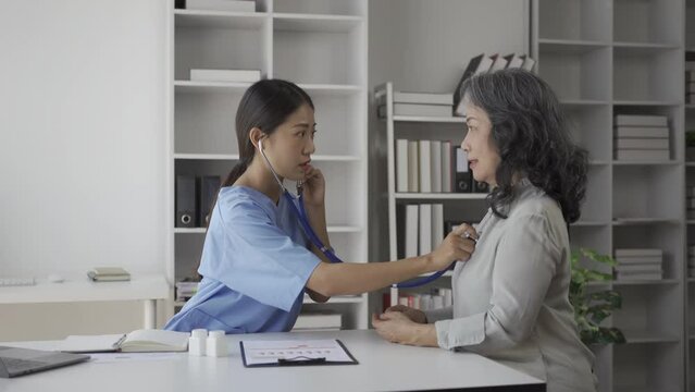 A nurse gives advice to an elderly person about his illness in the living room of his home. Providing medical care services at home Elderly patient care