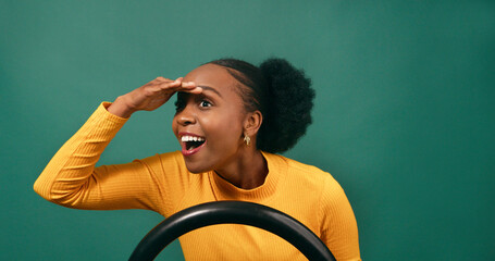 Woman driving car admires view, tourist vacation car hire, green studio backdrop
