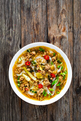 Yunnan rice noodle soup on wooden table