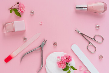 Composition of manicure and pedicure tools on pink background, flat lay. Cream, nail polish, file, scissors. Professional equipment for nail care. Beauty care concept for banner design.