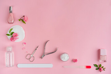 Set of manicure and pedicure tools for nail care and beauty on pink background. Beauty care concept for salon banner design.Manicure equipment with nail polish, scissors, cream and rose petal.