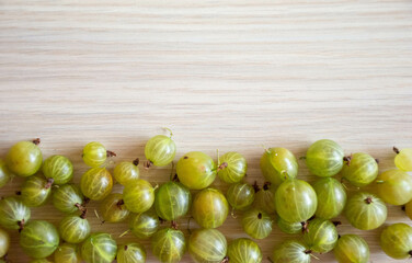  Gooseberries on a wood background .Healthy fruits on light wood background