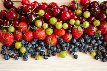 Berries variety, berries background with strawberries, gooseberry blueberries, blackberries. Healthy lifestyle concept.