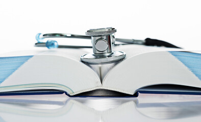 Stethoscope on a book isolated on white background