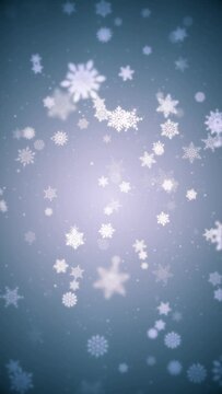 Vertical video - beautiful winter snowflakes and snow particles on blue background. This Winter snow, Christmas motion background animation is a seamless loop.