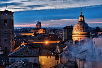 Night aerial view of the city of Reggio Emilia as seen from the tower of the church of San Prospero. Emilia Romagna, Italy - obrazy, fototapety, plakaty