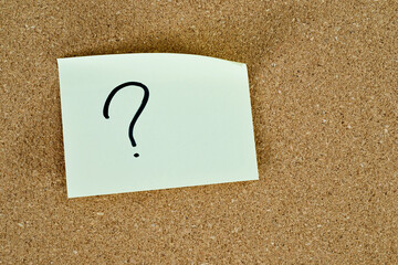Note question mark on cork board