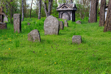 Old stone gravestones in the old abandoned cemetery