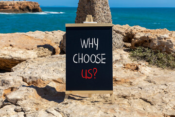 Why choose us symbol. Concept word Why choose us on beautiful wooden black chalk blackboard. Beautiful stone beach sea blue sky background. Business motivational why choose us concept. Copy space.