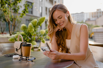 woman sitting in cafe with phone