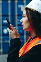 Profile portrait of Woman Engineer, Using a communication radio and working in Shipping Industry, logistic Import-Export Cargo Terminal