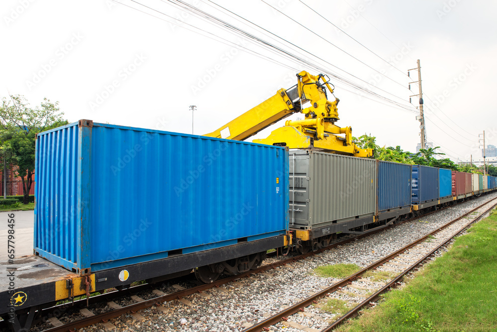 Wall mural reachstacker handling loading and unloand containers at rail transfer contaner station bangkok port