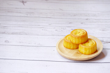 Mooncakes on wooden table. Mid-Autumn Festival background. Copy space.