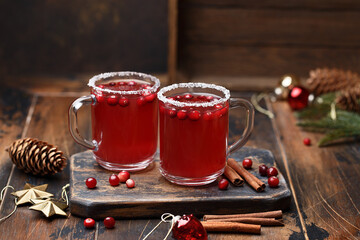 Hot cranberry tea with cinnamon sticks in glass mugs. Christmas and New Year concept