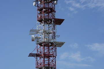 Part of construction of radio and television transmitter with plenty of broadcasting antennas of red and white color situated in Slovakia.