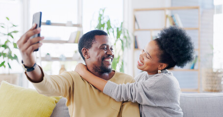 Fototapeta premium Happy African couple, selfie and sofa with hug, smile and post on web blog, love and bonding in home. Black woman, man and memory with photography, profile picture or romance on social media on house