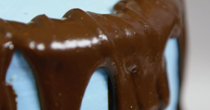Close-up of the hands of the woman who is cutting a chocolate cake
