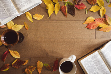 Two bibles and two cups of coffee on a light wood table