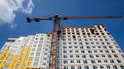 Work in progress on a new apartment block. Tall building under construction with cranes....