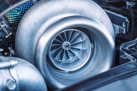 Close up of Turbo charger installed on car engine for power booster torque drive, Turbo car engine showing inner parts and turbine.